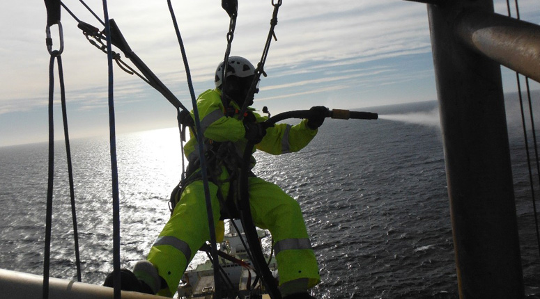 Image of rope access blasting and painting offshore for InterGroup's tank cleaning services and marine maintenance services in and around New Zealand, nationwide.