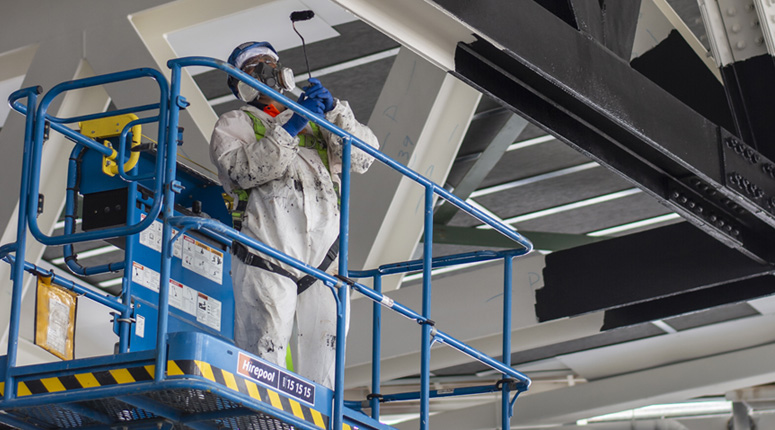 Technician applying Intumescent Coatings for fire protection in New Zealand